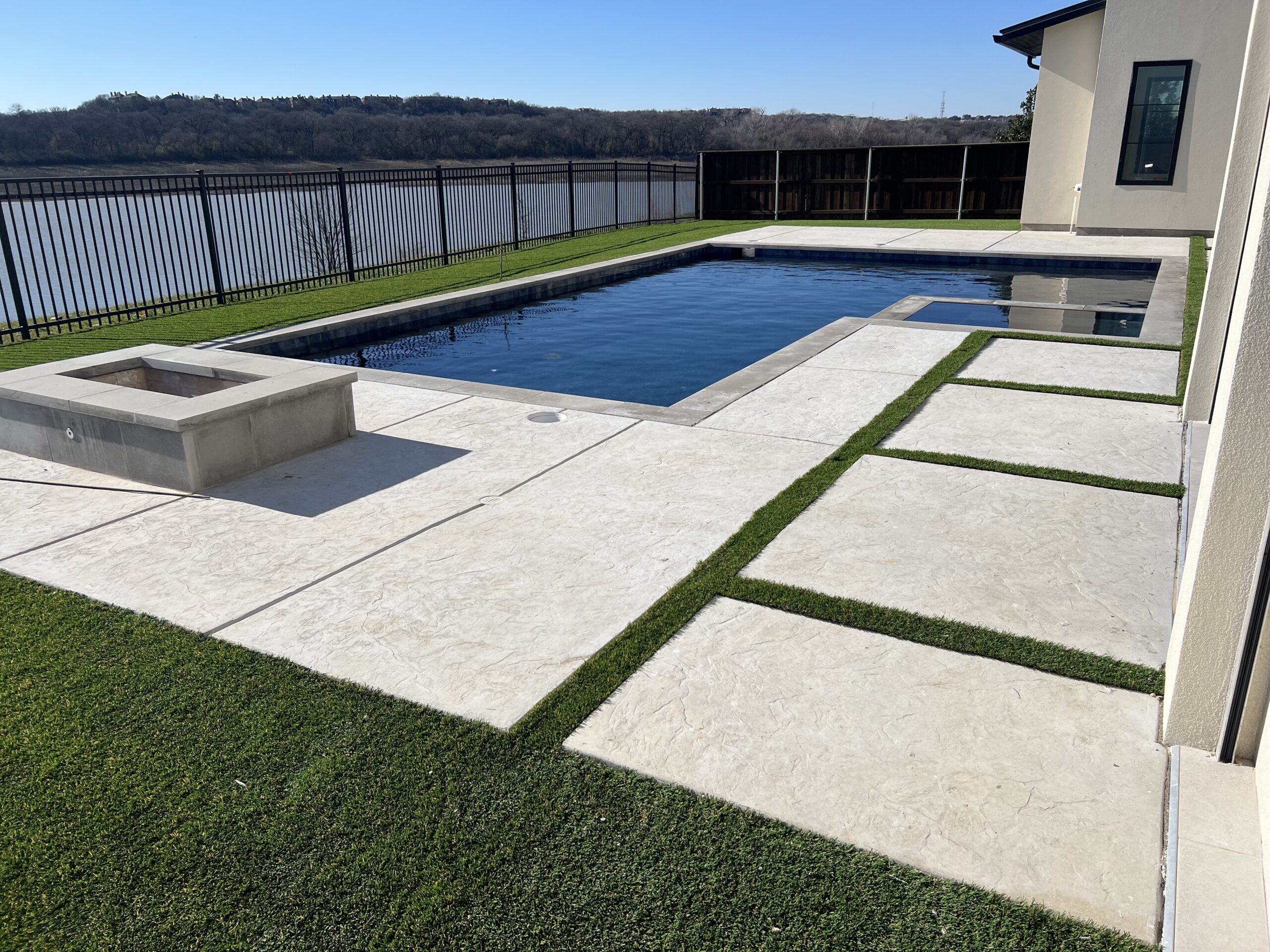 Green Forever Turf installation crew working on a backyard project