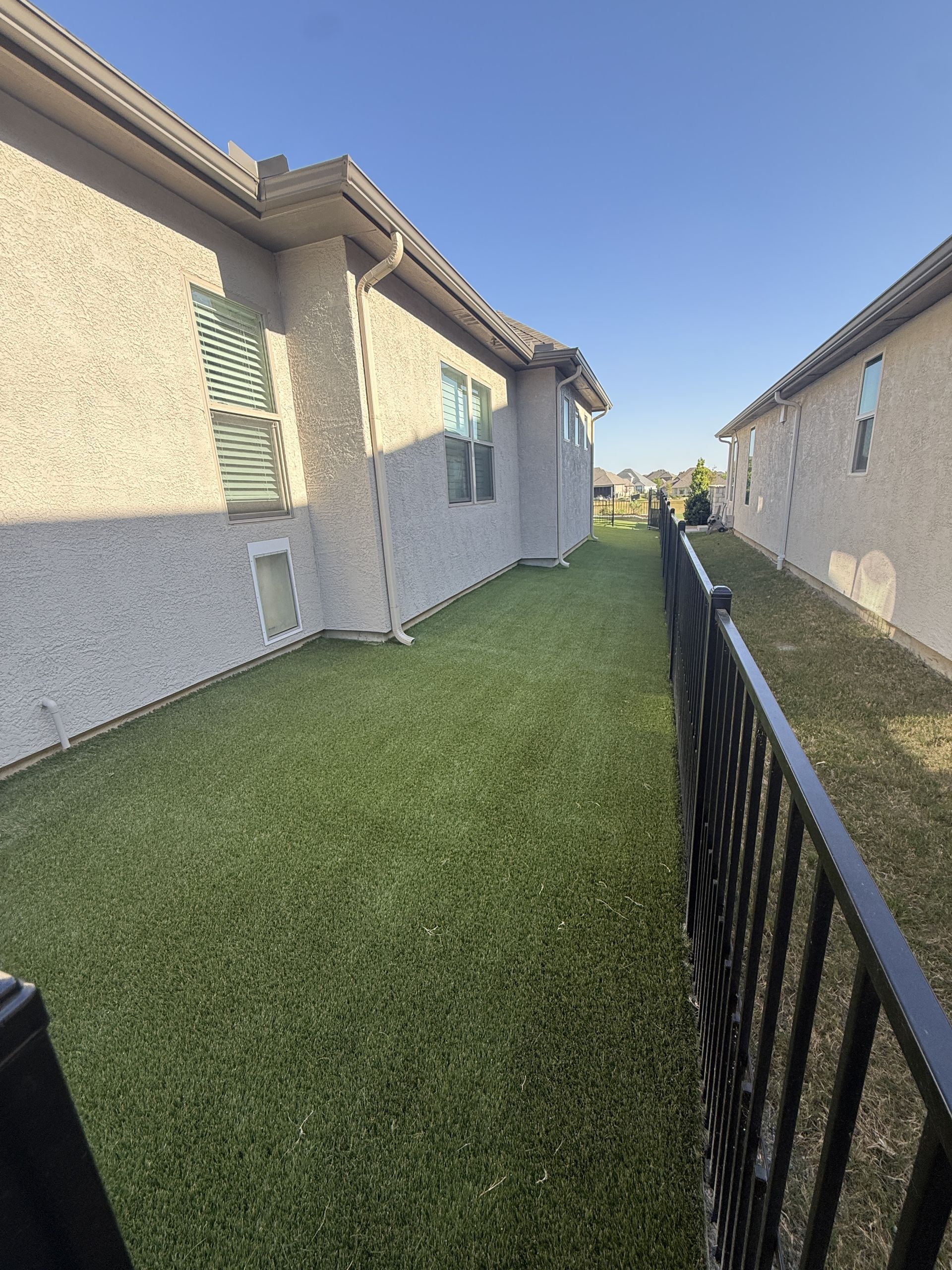 Artificial turf side yard installation along fence in DFW Texas