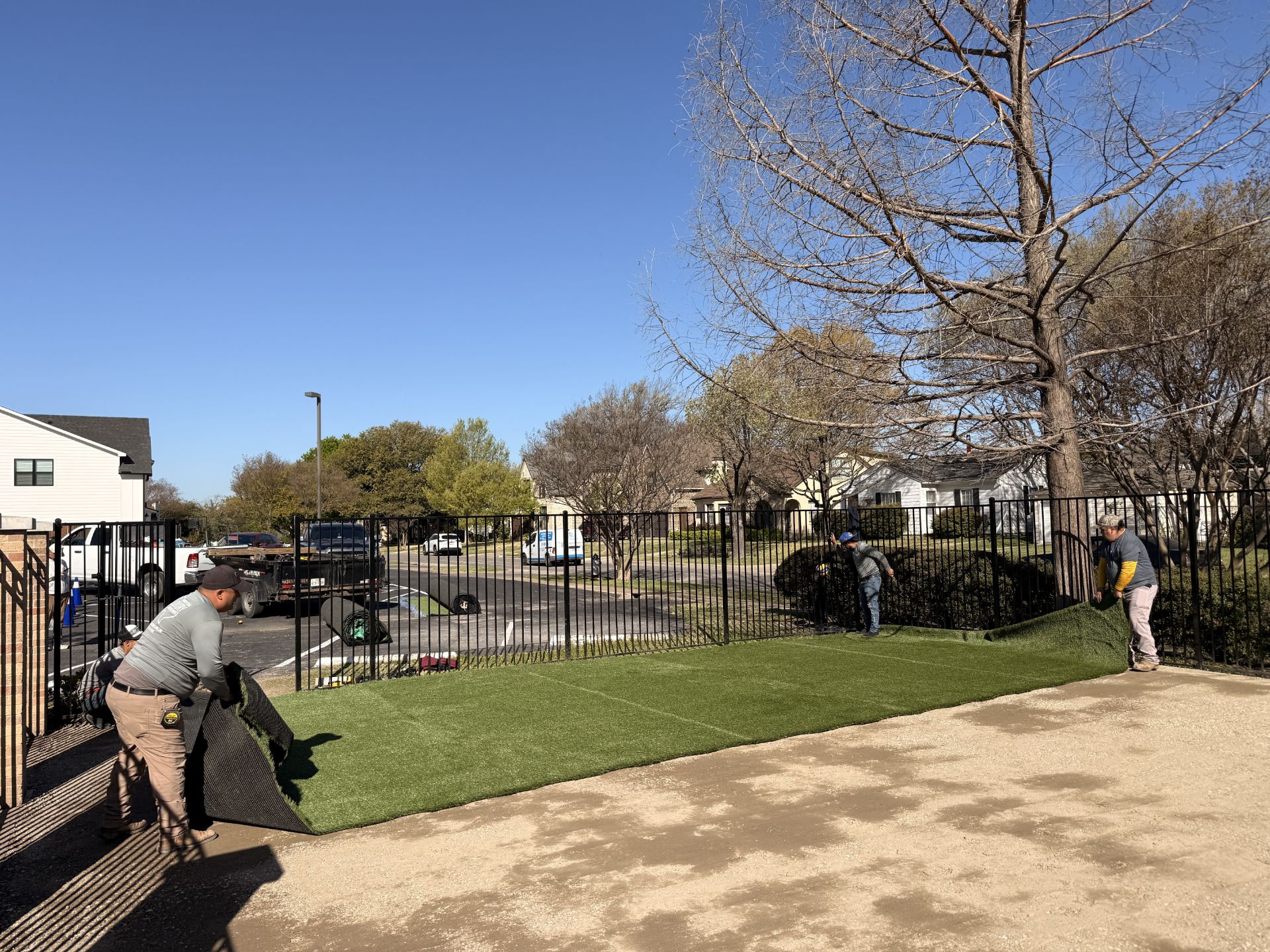 Crew laying synthetic turf field in Arlington TX area