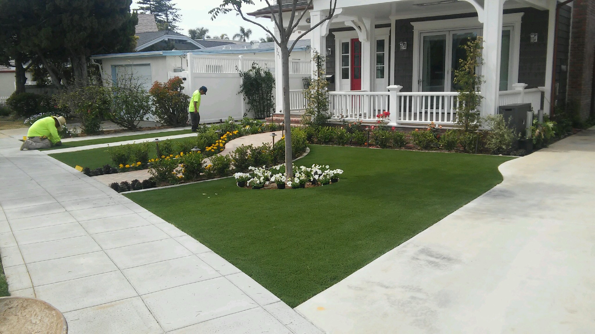 Green Forever installation crew finishing a front yard artificial turf install - Green Forever Turf Texas