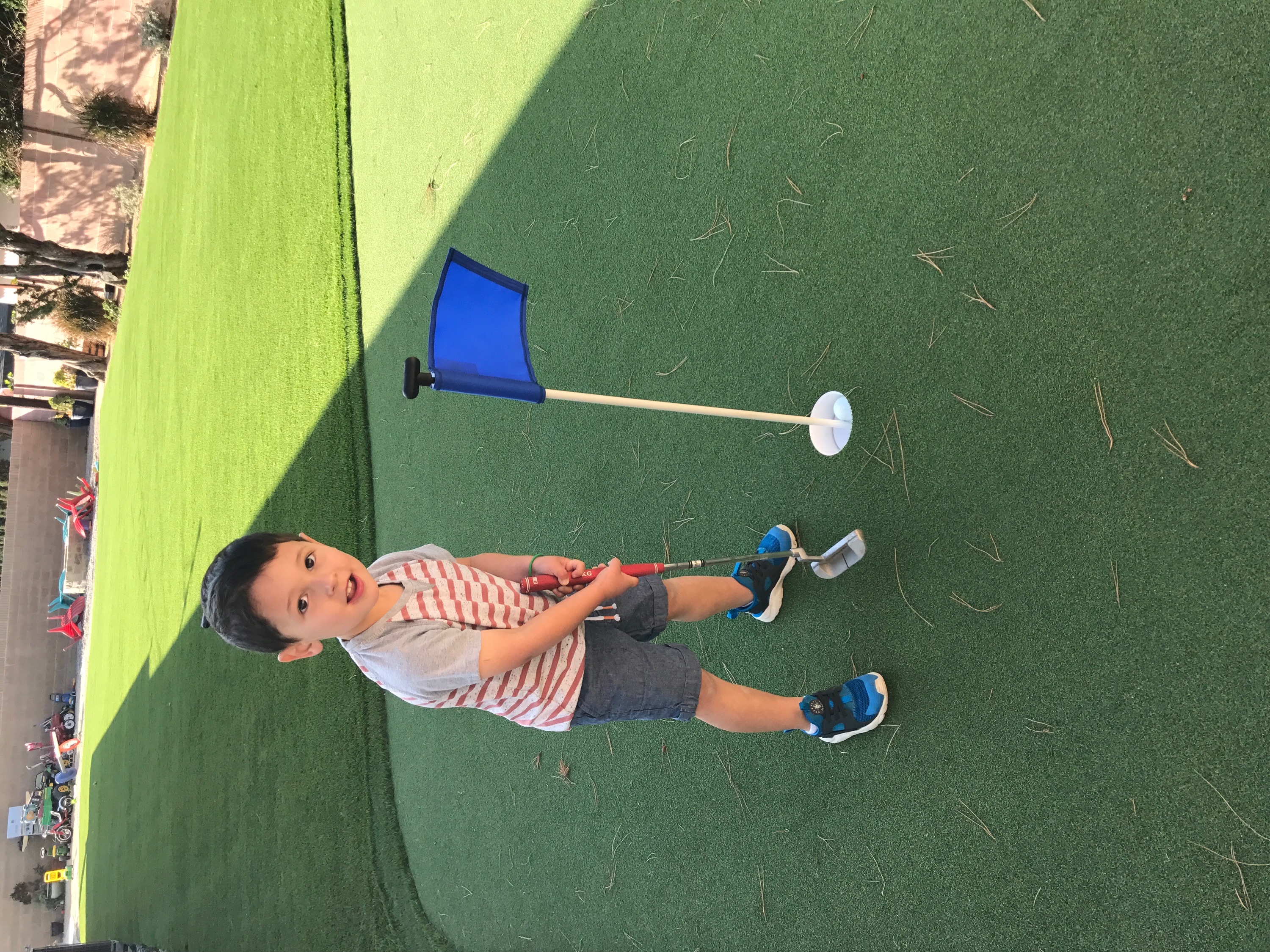 Putting green child chipping practice - Green Forever Turf Texas
